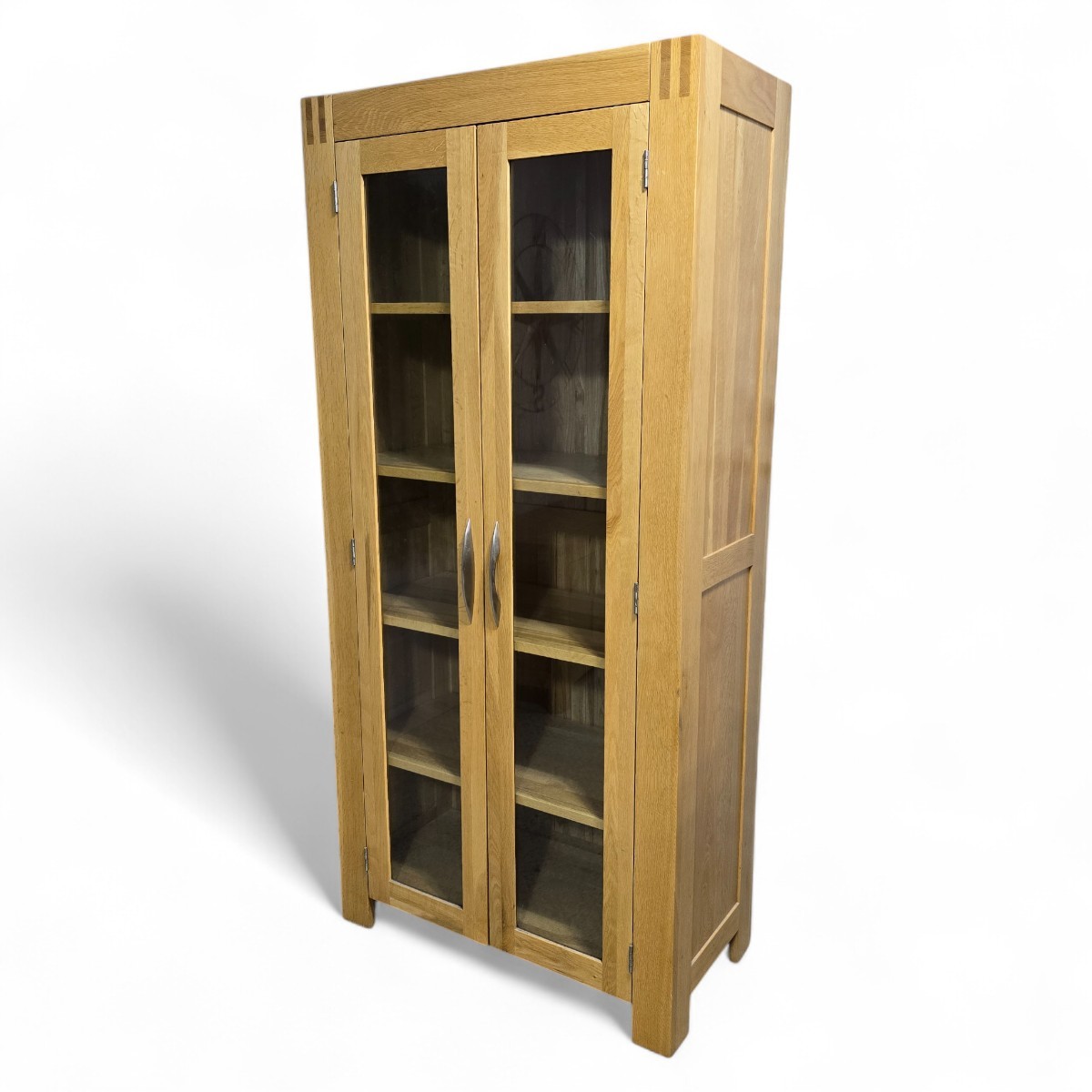 Pre-loved Oak FurnitureLand Alto range display unit made from solid oak featuring glass doors and five fixed shelves in light oak finish.