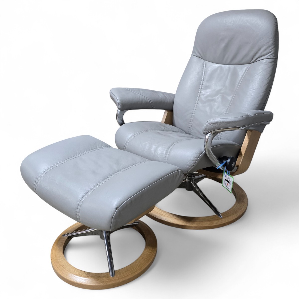 Pre loved Stressless Consul recliner and footstool in soft grey leather with polished chrome legs and oak base offering modern elegance