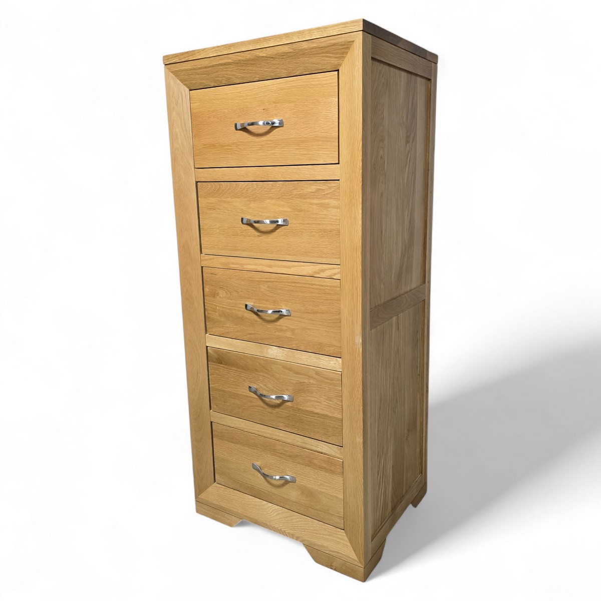 Solid oak Bevel tallboy from Oak Furniture Land with five dovetailed drawers, brushed metal handles and compact footprint, perfect for any room in your home.