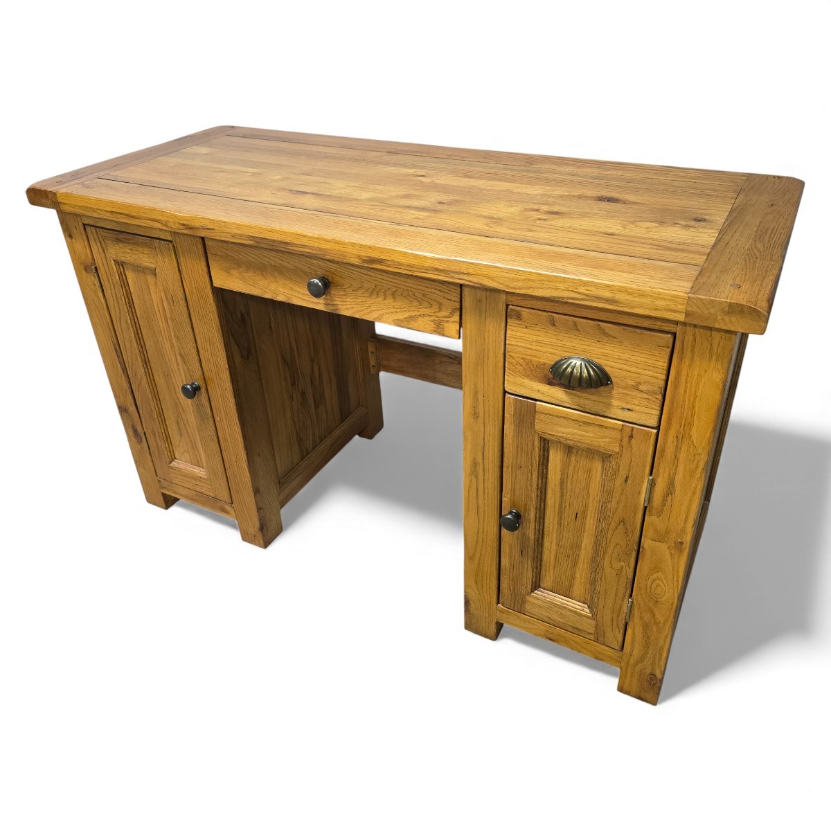 Warm medium oak desk with shell-shaped handles and round knobs, perfect mix of function and classic design from Barker and Stonehouse.
