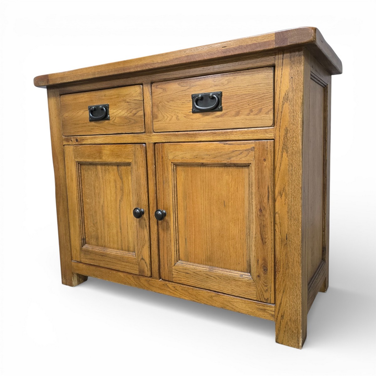 Second hand Barker and Stonehouse solid oak sideboard with two drawers and a double-door cabinet, featuring black metal handles and block legs.